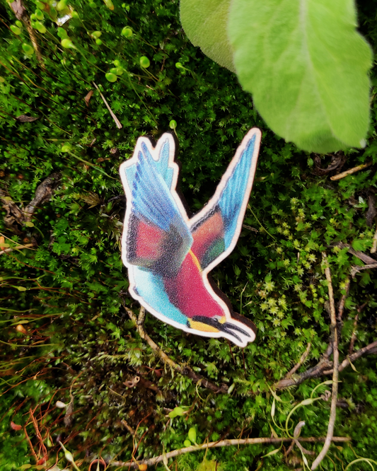 Wooden pin of a European Bee Eater on mossy background.