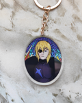 Keychain of Dimitri from Fire Emblem on a marble surface