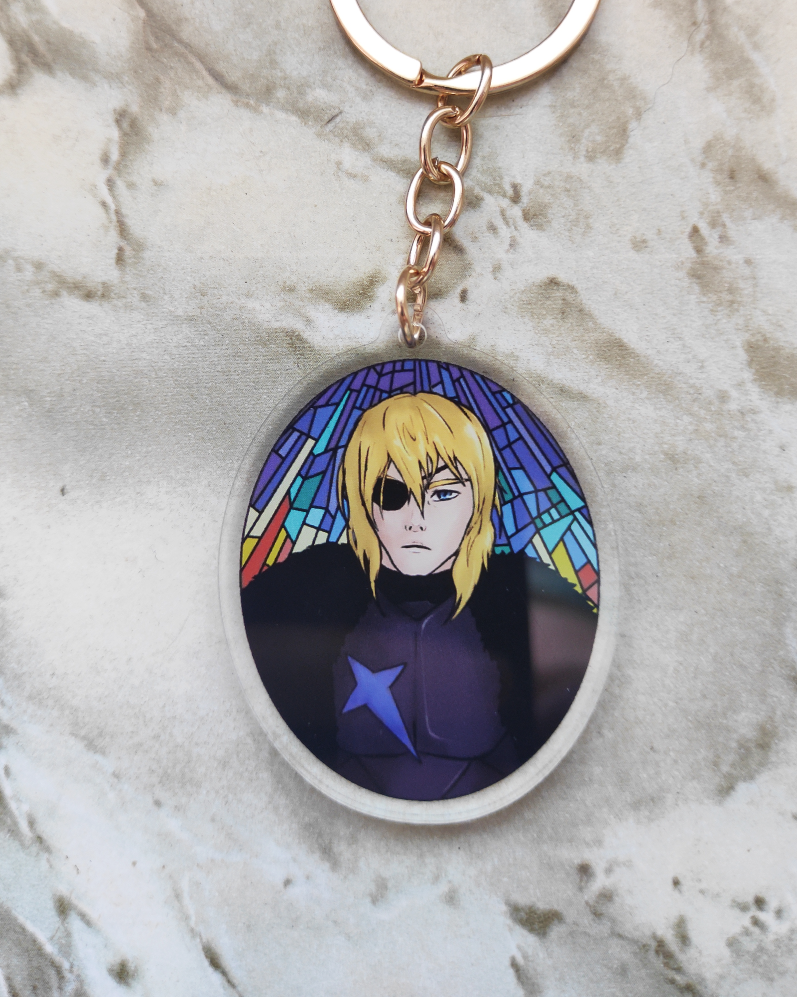 Keychain of Dimitri from Fire Emblem on a marble surface