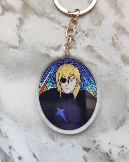 Keychain of Dimitri from Fire Emblem on a marble surface