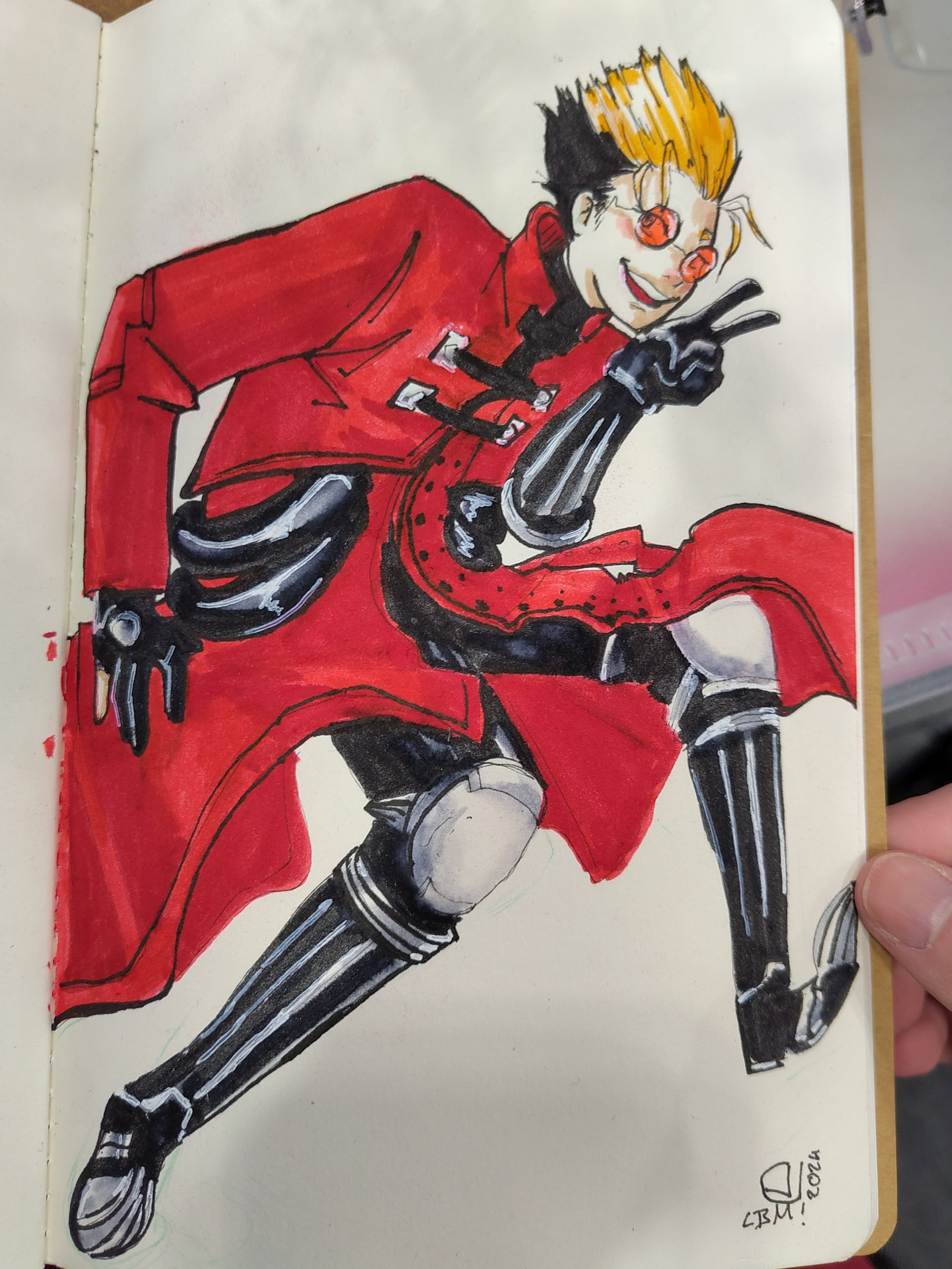 Photo of a commission of Vash the Stampede, main character of trigun in his signature red coat. He is smiling and showing off a peace sign.