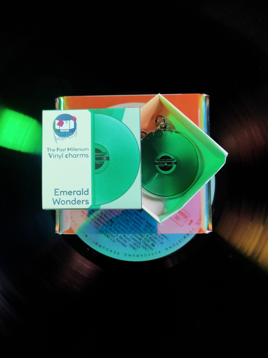 Green vinyl record with packaging labeled 'Emerald Wonders' on a dark background